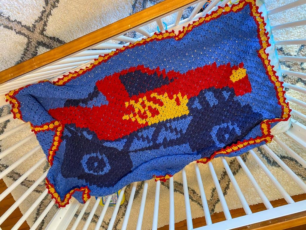 You can make this easy C2C crochet Monster Truck Blanket! Free pattern for any eager beginner. Perfect size for a crib, toddler or twin sized bed. Using Lion Brand Pound of Love yarn. 