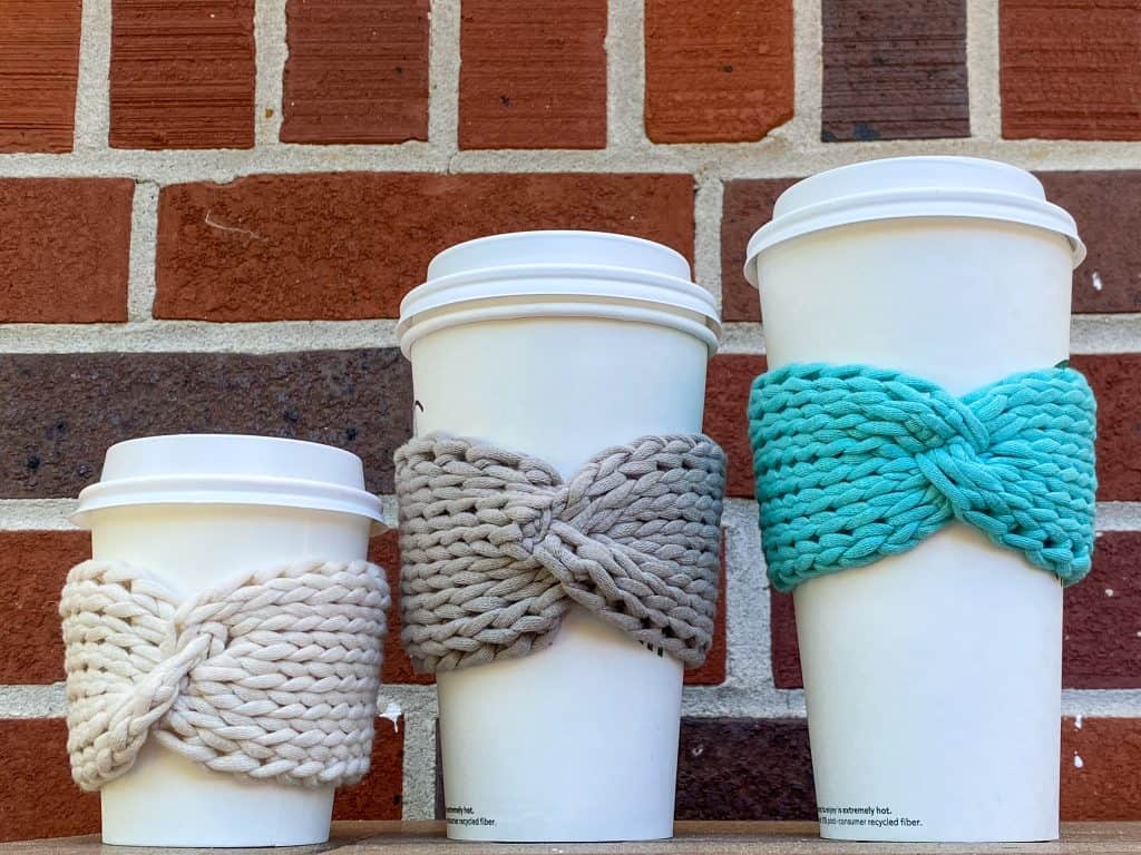 Looking for a stylish eco-friendly alternative to the paper coffee sleeve? Look no further than my Tunisian Knit Bow Coffee Sleeve pattern. This FREE easy crochet pattern is perfect for the eager beginner wanting to try Tunisian Crochet. Plus it uses a regular 10mm crochet hook and only 1/2 an ounce of Bernat Maker Home Dec Yarn. Fits any size coffee cup (from 8oz to 20oz). 