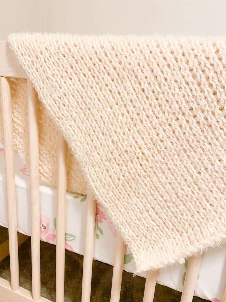 Tunisian Knit Stitch and Red Heart Hygge yarn makes a super soft and squishy blanket perfect for baby's delicate skin. Easily make this blanket in any size! Works up super quickly you can easily be done in a weekend. 