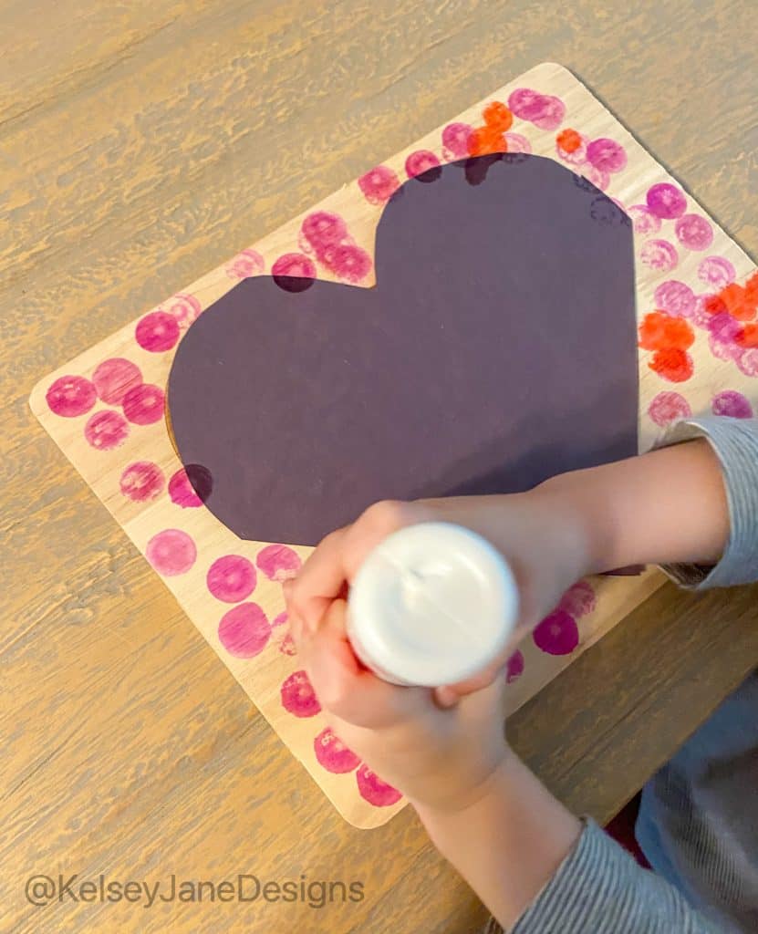 Super simple DIY handprint, or footprint, Valentine's Day home decor project that's toddler approved! Using the heart charcuterie boards from Target's Bulleyes Playground, paint, and dot markers. You'll quickly have a wonderful Valentine's Day gift for grandparents or loved ones. 
