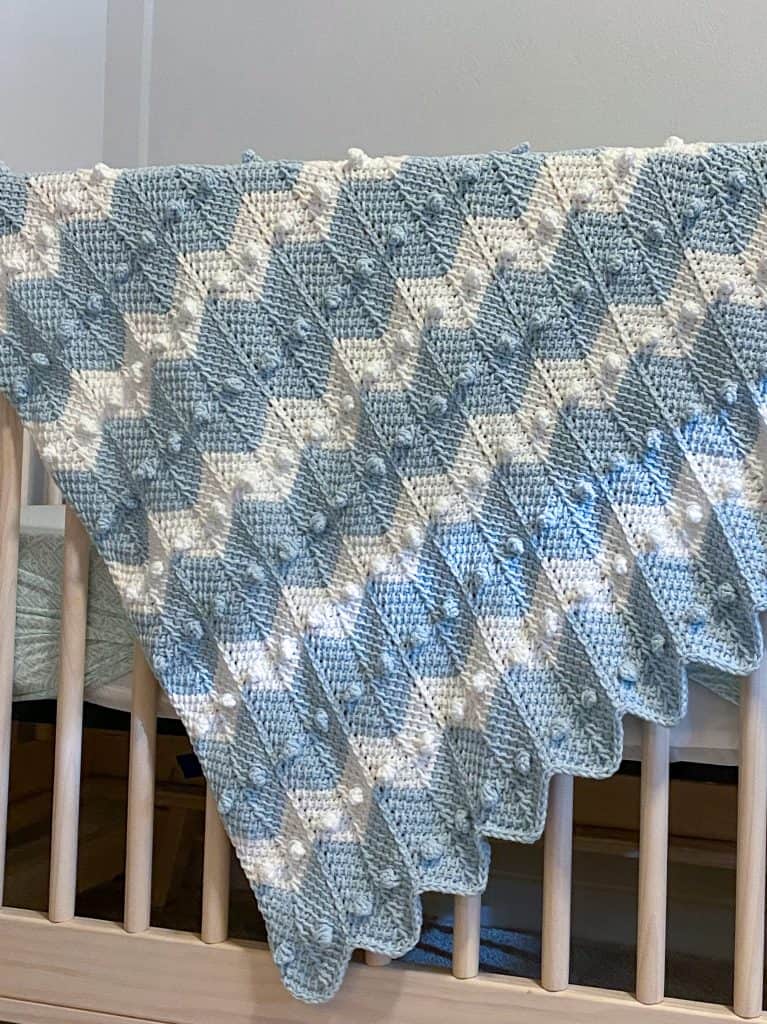 Learn how to crochet the bobble chevron baby blanket using tunisian crochet! If you can crochet a bobble and the tunisian simple stitch this will be super easy! Using Lion Brand's Feels Like Butta yarn. 