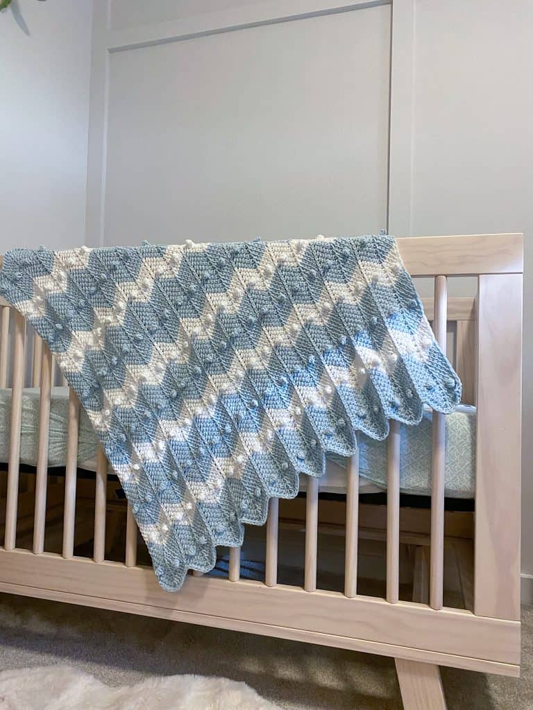 Learn how to crochet the bobble chevron baby blanket using tunisian crochet! If you can crochet a bobble and the tunisian simple stitch this will be super easy! Using Lion Brand's Feels Like Butta yarn. 