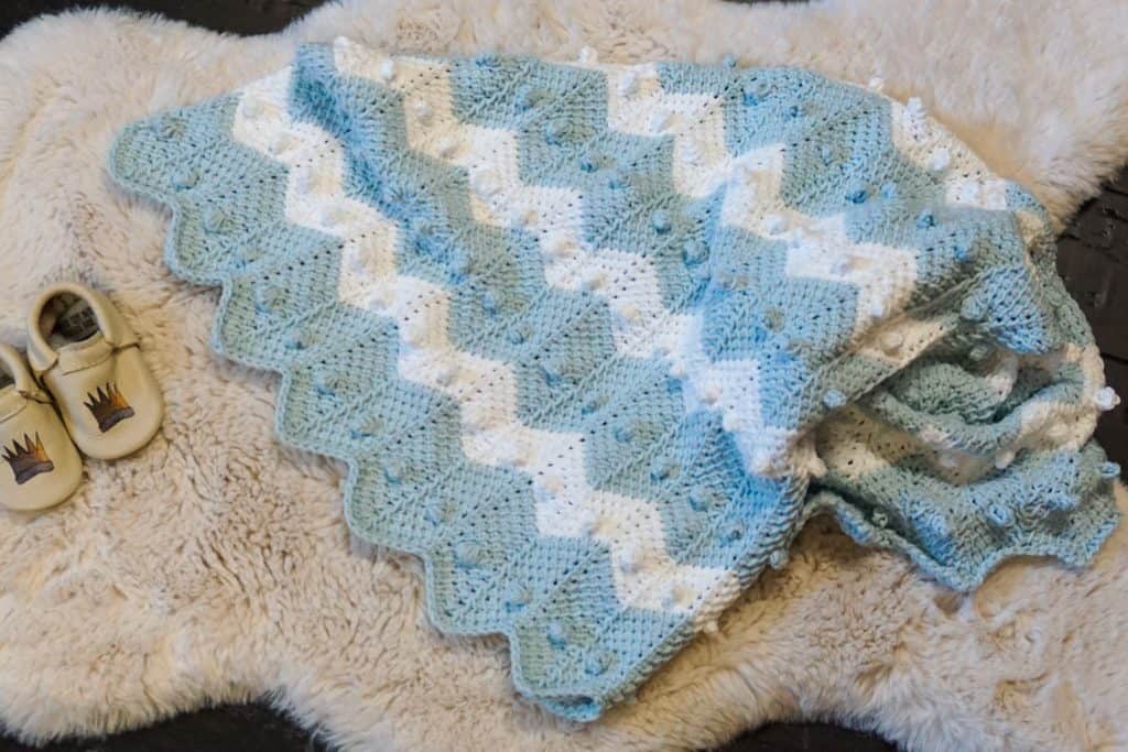 Learn how to crochet the bobble chevron baby blanket using tunisian crochet! If you can crochet a bobble and the tunisian simple stitch this will be super easy! Using Lion Brand's Feels Like Butta yarn. 