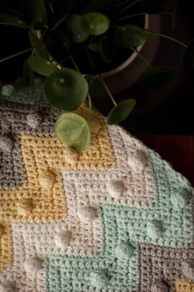 Learn how to crochet this timeless bobble chevron baby blanket with step by step instructions and YouTube video tutorial. 
