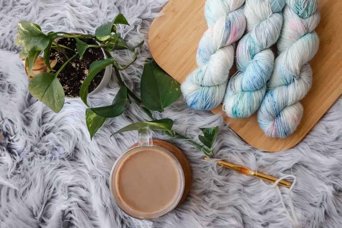 Blue and white yard with coffee cup on gray rug.